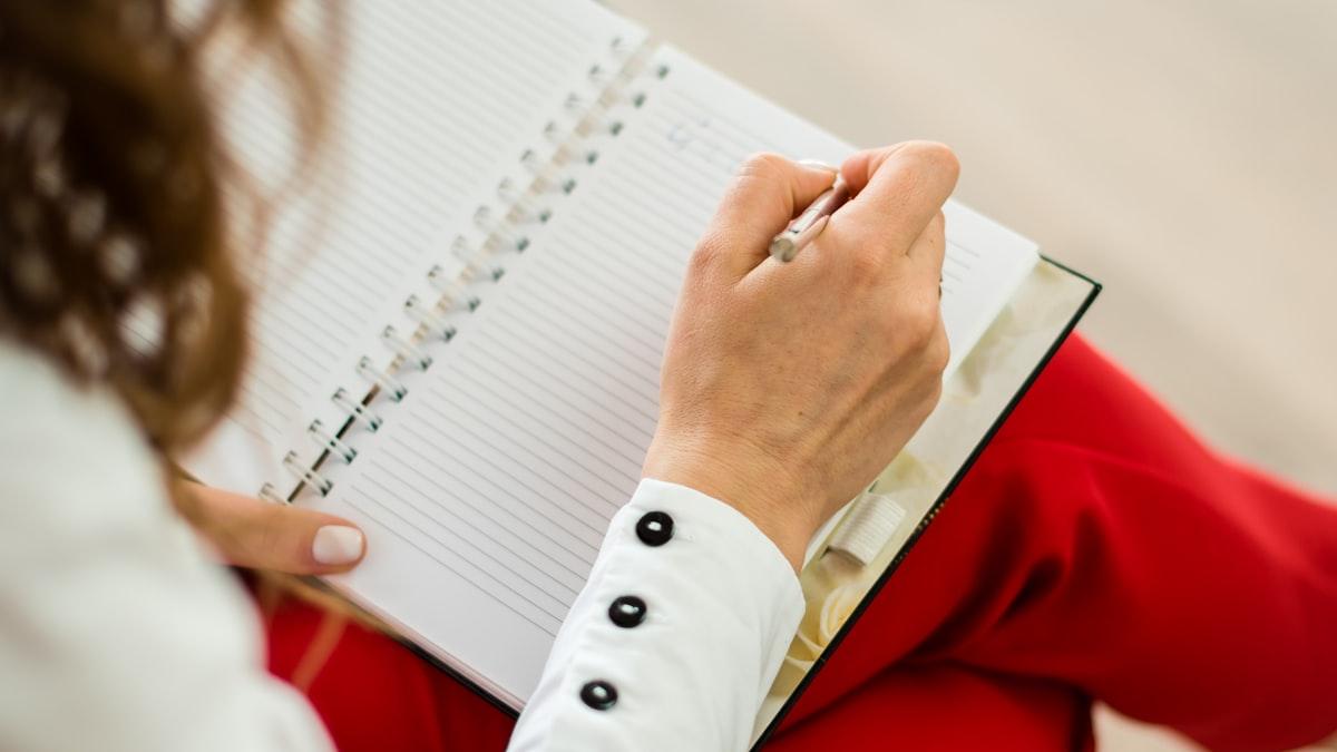 A therapist sits across from a client mid-session, listening, no laptop between them