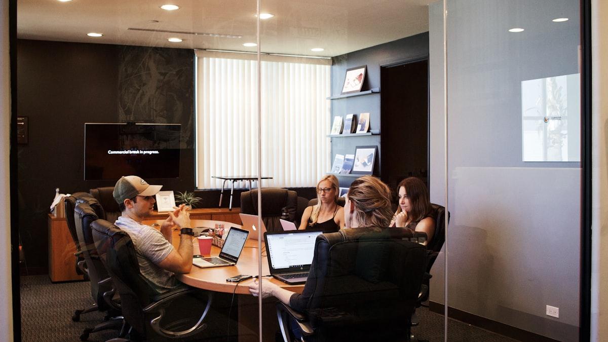 A clinic director going over the week's numbers with a team of therapists